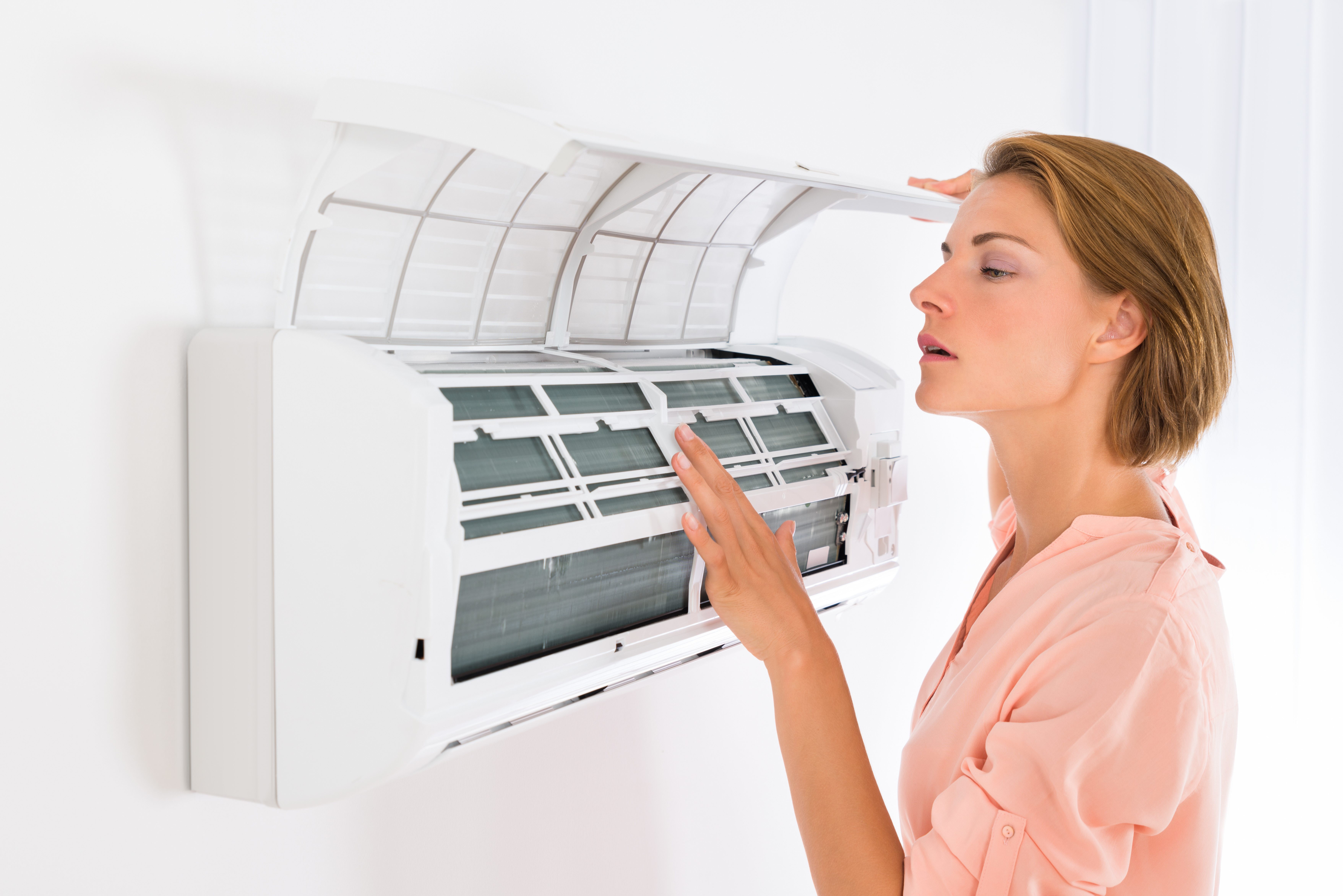 Woman Checking on AC in Granbury, Texas