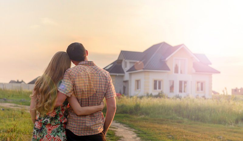 Husband and wife holding each other while they look at their home in Granbury, TX. They know the importance of air conditioning maintenance.